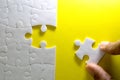 Close up piece of the white jigsaw puzzle , concept of business challenge completion with teamwork Royalty Free Stock Photo