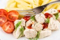 Close-up of pieces of chicken, pasta and tomatoes