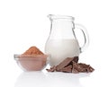 Close-up pieces of chunk black chocolate with glass bowl of cocoa powder andÃ¯Â¿Â½jug of milk