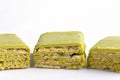 Close up pieces of green waffles containing matcha green tea on white background