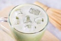 Close up of a pieces of ice in a glass with fresh matcha latte, green tea with milk Royalty Free Stock Photo
