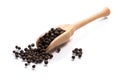 Close-up of pile of Black pepper seeds spice in a wooden spoon o