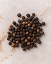 Close-up of a pile of black peppercorns on a marble surface Royalty Free Stock Photo