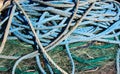Close up of pile of blue ship ropes on green isolated fishing net Royalty Free Stock Photo