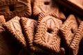 A close up of a pile of brown cookies called speculaas or speculoos in Belgium or the Netherlands. The spiced biscuit is very