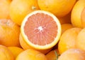 Close up on pile of Cara Oranges, one sliced in half for display at Farmers Market Royalty Free Stock Photo