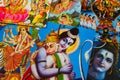 Close up of pile of classical Indian colorful paintings about mythology of hindu gods. focus on hanuman embracing shiva