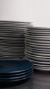 Close-up of pile of clean plates. Stack of dishes. Pieces of white and blue ceramic plate