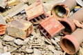 Close up of a pile of construction waste after demolishing an old building. Broken bricks, cement pieces and stoneware water-