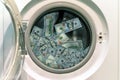 Close-up Of Pile Of Dirty Money Placed In Washing Machine