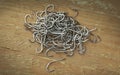 Close up, Pile of fish hooks on wooden plank background Royalty Free Stock Photo