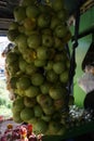 Close up of pile of fresh local green apples in fruit basket hanging on traditional fruit shop for sale Royalty Free Stock Photo