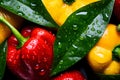 Close up of pile of juicy fresh peppers with leaves