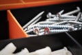 Close up of pile of metal screws in a toolbox