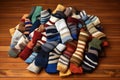 close-up of a pile of mismatched socks on a wooden floor