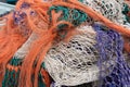 Close up of a pile of old fishing nets in orange green purple and white Royalty Free Stock Photo