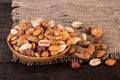 Close Up Of Pile Of Organic Raw Nuts Mix Of Pistachios, Almonds, Walnuts, Dried Mulberries, Dried Figs And Hazelnuts On Wooden Pl