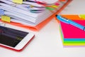 Close-up of a pile of paper with colored post its and a pen. Royalty Free Stock Photo