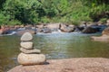 Close up pile of pebbles with beautiful landscape view of small waterfall in the river with water stream flowing through stone.