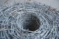 Close up on a pile roll of shiny new barbed wire for fence fencing. Security protection law enforcement. Prison jail Royalty Free Stock Photo