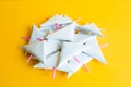 Small white paper firecrackers on festive yellow background Royalty Free Stock Photo