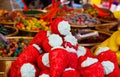 Close up of pile of sweets in shape of strawberry with blurred bowels filled with sweet candies on French market