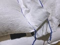 Close-up Pile of White Plastic Sacks with Blue Threads