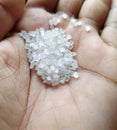 Close up of a pile of white sugar crystals in human hand Royalty Free Stock Photo