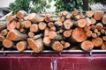 Close up piled of wood logs overlap in old red pickup truck , Transportation background Royalty Free Stock Photo