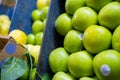 Piles of fresh and juicy-looking green apples on a fruit stand