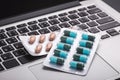 Pills on a laptop, Healthy and hard work concept. Selective focu
