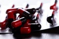 Close-up Pills red anf black on Tablets. Medical background Royalty Free Stock Photo