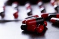 Close-up Pills red anf black on Tablets. Medical background Royalty Free Stock Photo