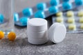 Close up of pills and vitamins on gray background