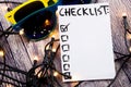 Close up of pin and to do list Checklist word on sticky note with wooden background Royalty Free Stock Photo