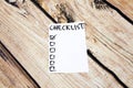 Close up of pin and to do list Checklist word on sticky note with wooden background Royalty Free Stock Photo