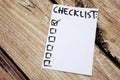 Close up of pin and to do list Checklist word on sticky note with wooden background Royalty Free Stock Photo
