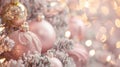 Close-up of pink Christmas ornaments on a frosted tree with glowing lights Royalty Free Stock Photo