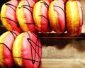 Close up pink donuts on tray with copy space on right at bakery store.