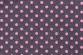 Pink dots over purple polka dot fabric background and texture. Royalty Free Stock Photo
