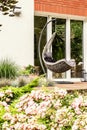 Close-up of pink flowers with a single swing on a terrace in the