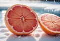 Close-Up of Pink Grapefruit Halves in Snowy Scene Royalty Free Stock Photo