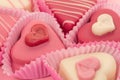 Close-up of a pink heart shaped petit fours cakes seen from the side Royalty Free Stock Photo