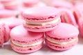 close-up of a pink macaron with bite taken out