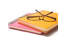 Close-up of pink orange note book and eye-glasses Royalty Free Stock Photo