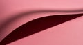A close-up of pink paper with a subtle fold creating a shadow. The texture appears smooth, and the Royalty Free Stock Photo