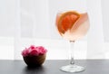 Close up pink pastel cocktail in tall glass on dreamy white background