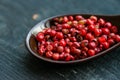 Close up pink peppercorn in spoon dark background Royalty Free Stock Photo