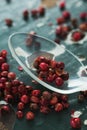 Pink peppercorn and spoon on wooden table Royalty Free Stock Photo