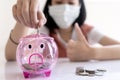 Close up of pink piggy bank,Concept of frugal,thrifty and economical, good saver, asian child girl put coin into piggy bank,saving Royalty Free Stock Photo